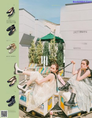 A couple of women standing next to each other on a balcony.