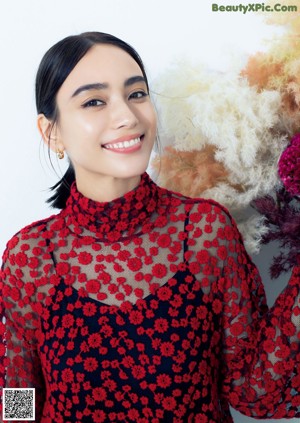A woman holding a bunch of flowers in her hands.