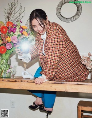 A woman sitting at a table with a plate of food.