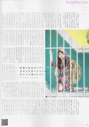 A woman in a floral dress standing on a stairwell.