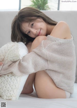A woman in a pink jacket and white underwear posing for a picture.
