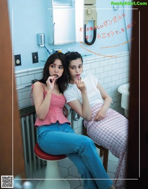 A couple of women sitting in the back seat of a car.