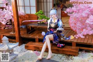 A woman sitting on a wooden bench holding a cell phone.