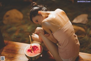 A woman laying on the floor with her legs crossed.