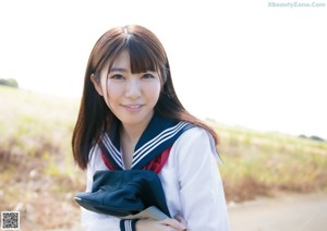 A woman in a sailor outfit posing for a picture.