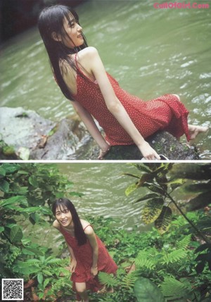 A woman in a red dress looking up at the sky.