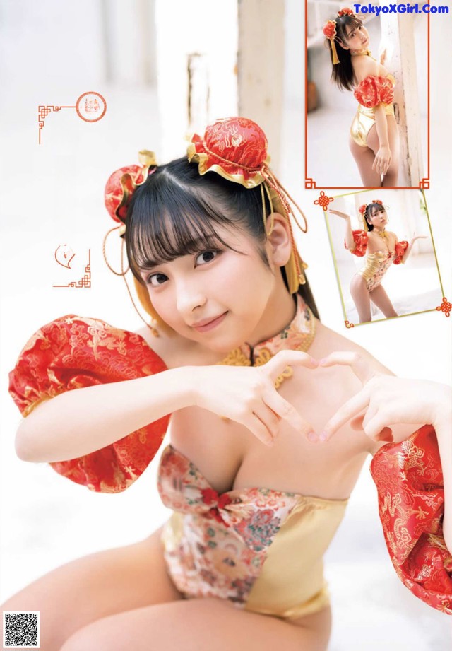 A woman in a red and gold outfit making a heart with her hands.