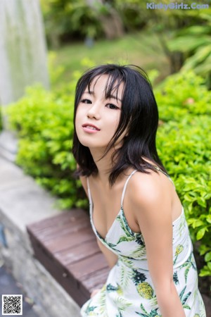 A woman in a white dress posing for a picture.