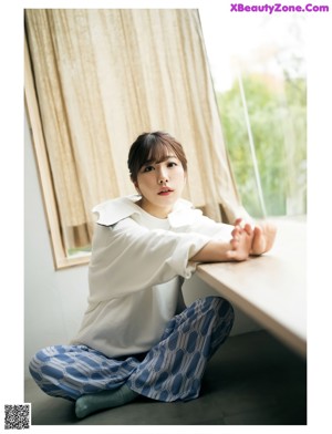 a woman in a blue jacket and red pants