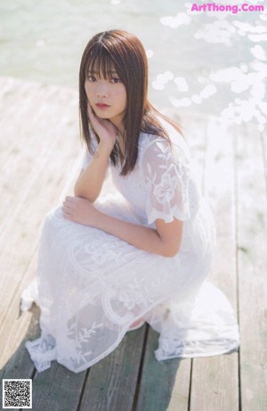 A woman laying on top of a wooden table.