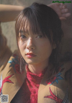 A magazine spread with a picture of a woman sitting on a train.
