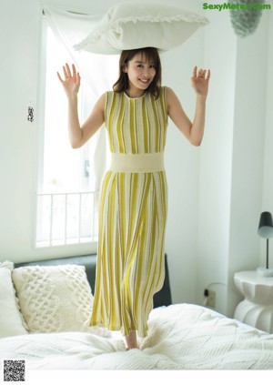 A woman in a yellow and white striped dress.